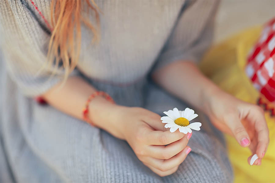 holding a daisy
