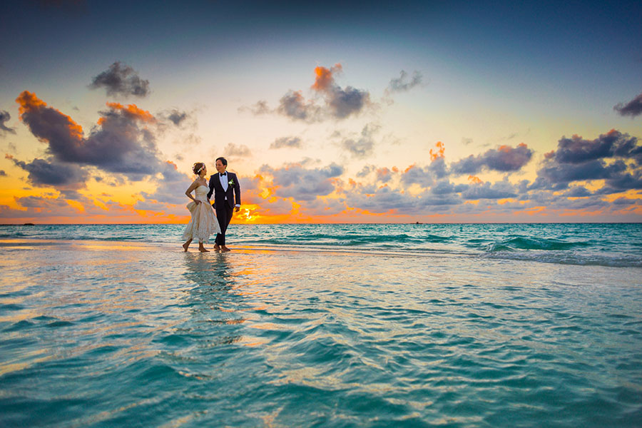 wedding couple walking in the water