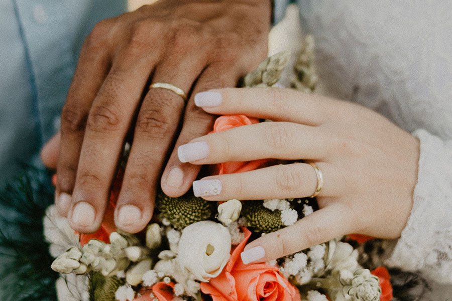 Wedding couple hands with bouquet